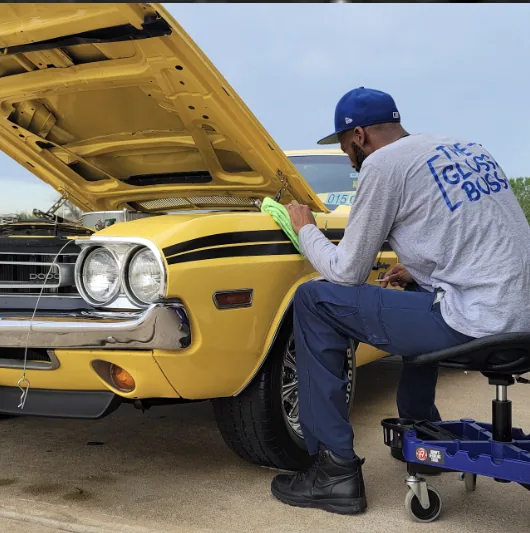 Detailing a yellow 1971 Dodge Challenger with the hood up
